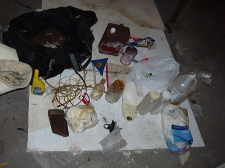 Seized meth lab solvents and tubing inside a property