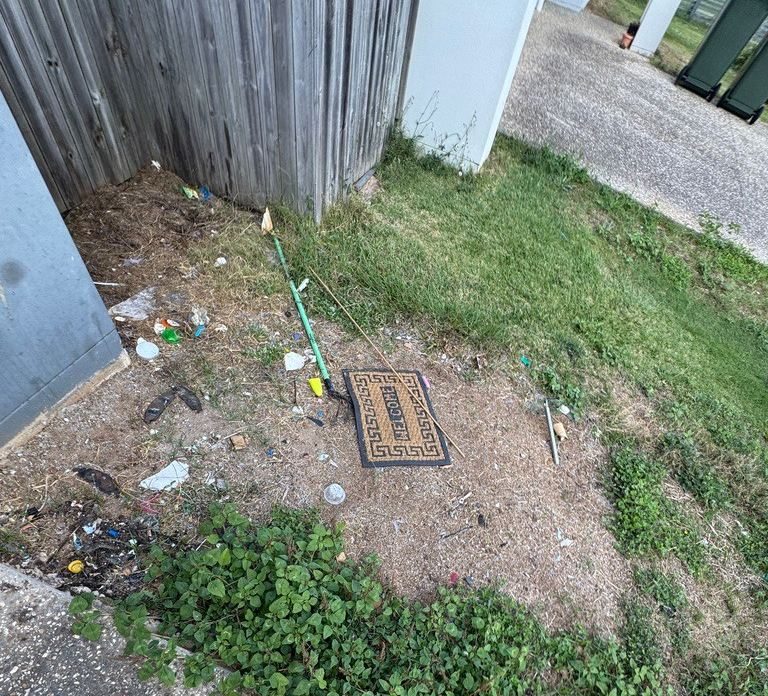Rubbish and debris dumped in a rental backyard — real Brisbane rental