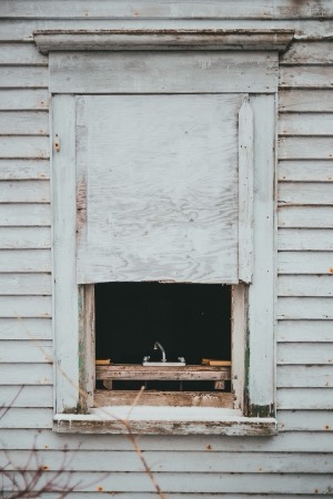 Boarded-over house window